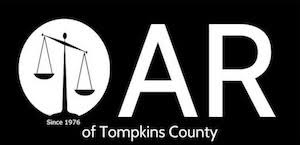 The letters O A R. There is a scale of justice sitting inside the "O". Underneath it says "of Tompkins County."