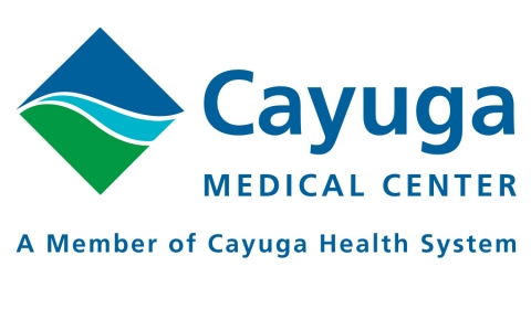 A diamond shows a blue sky with a light blue river running next to a field of green grass. Next to it are the words Cayuga Medical Center. Underneath reads: A Member of Cayuga Health System